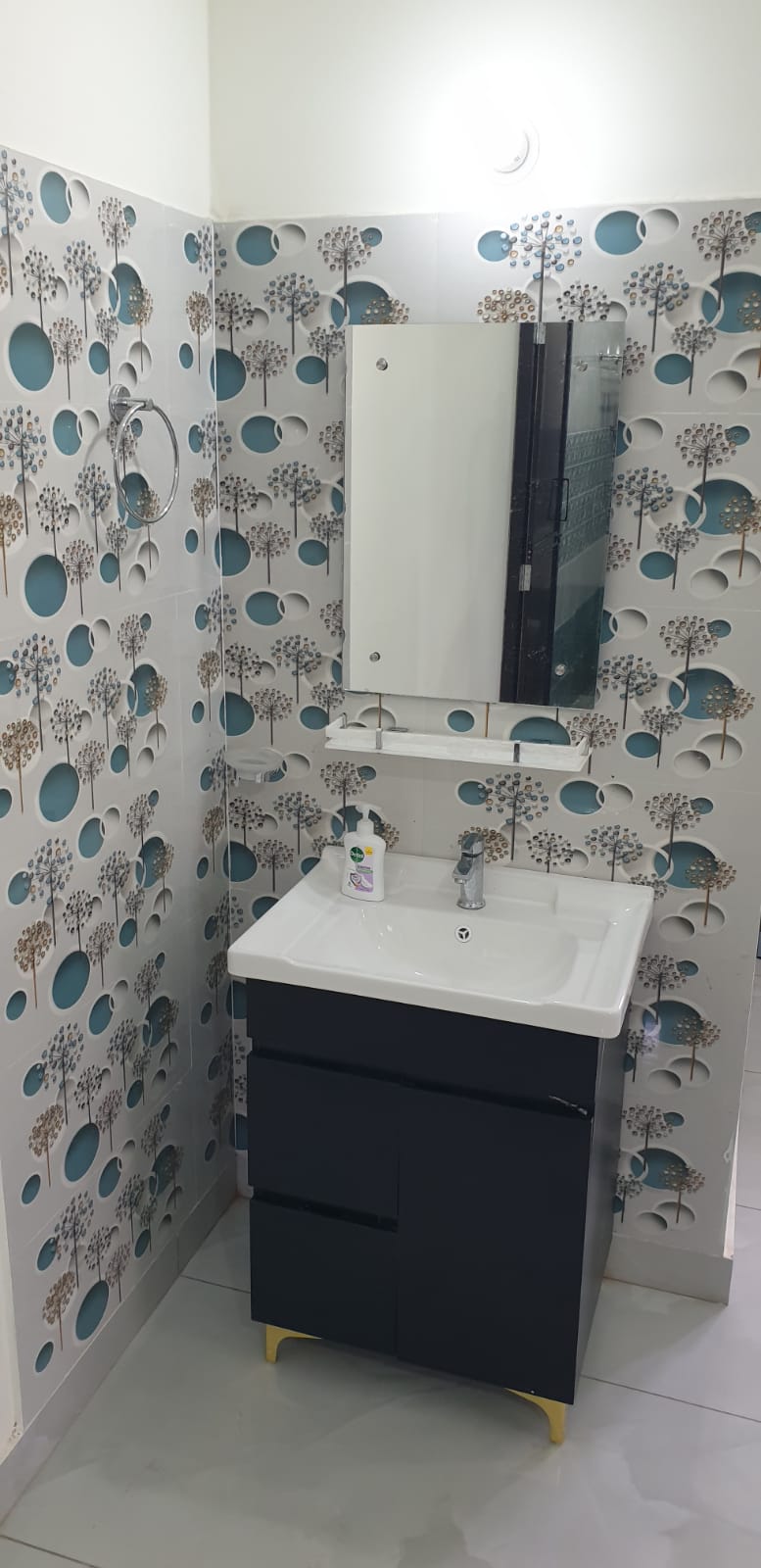 Bathroom with dandelion tiles and navy vanity