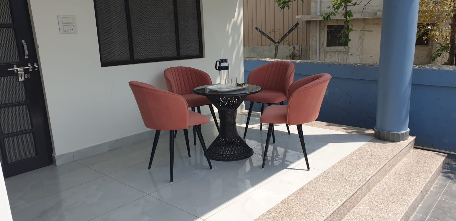 Covered outdoor veranda with chairs at Ashirwad Homestay