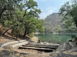 Garudtal lake — serene forest lake with stone steps and dense green trees