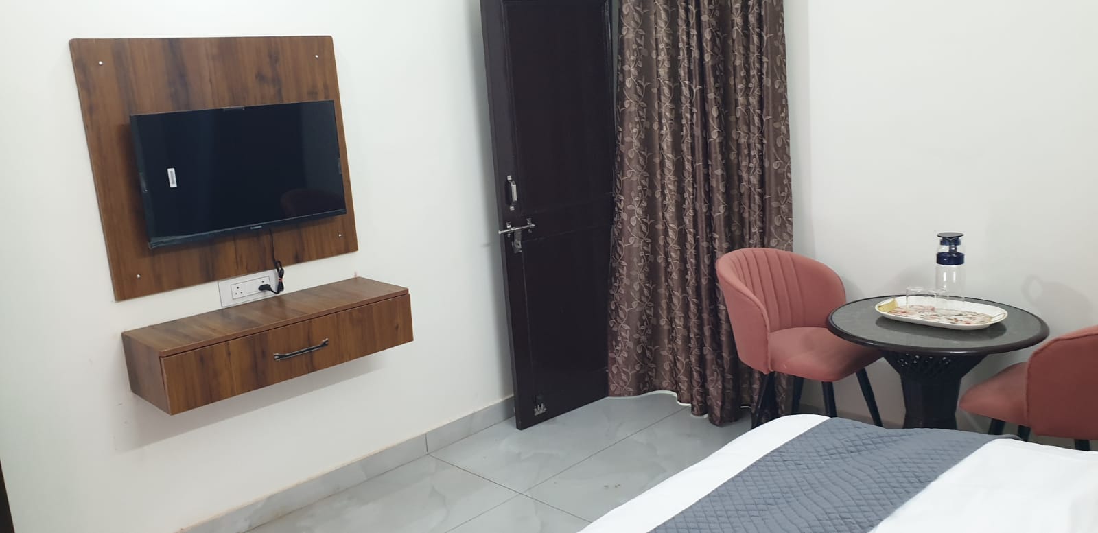 Double room — TV panel and chairs angle